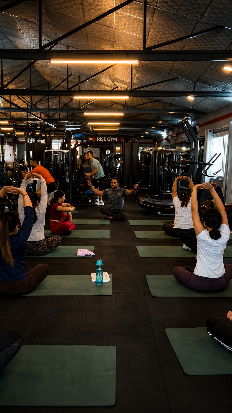 Group class on training mats at Rise Fitness