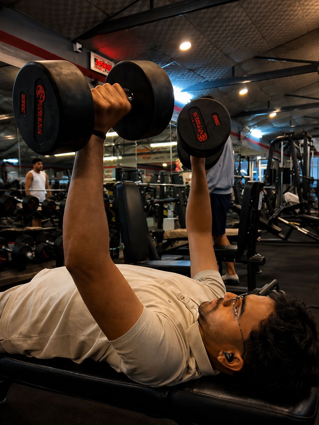 Weight training with dumbbells at Rise Fitness